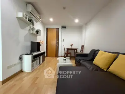 Modern living room with sleek furniture and wooden flooring, perfect for cozy urban living.